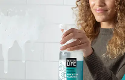 woman spraying cleaning product 