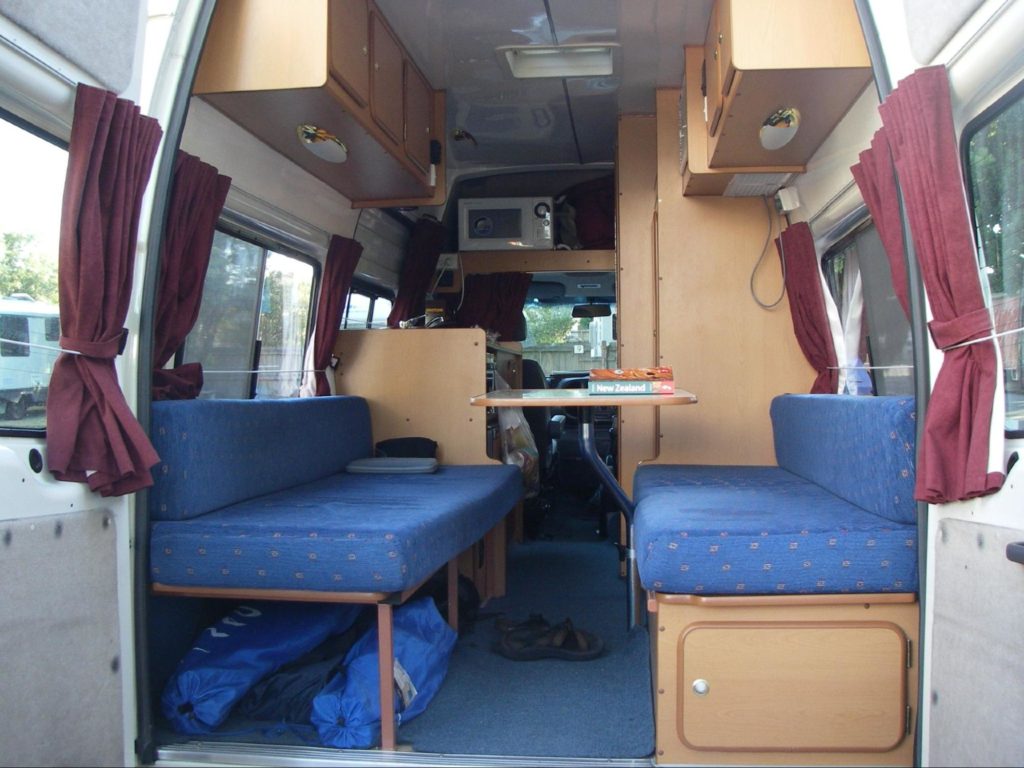 inside of a camper with back doors open