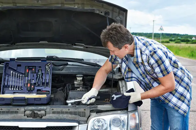 man doing Emergency Repairs on a vehicle