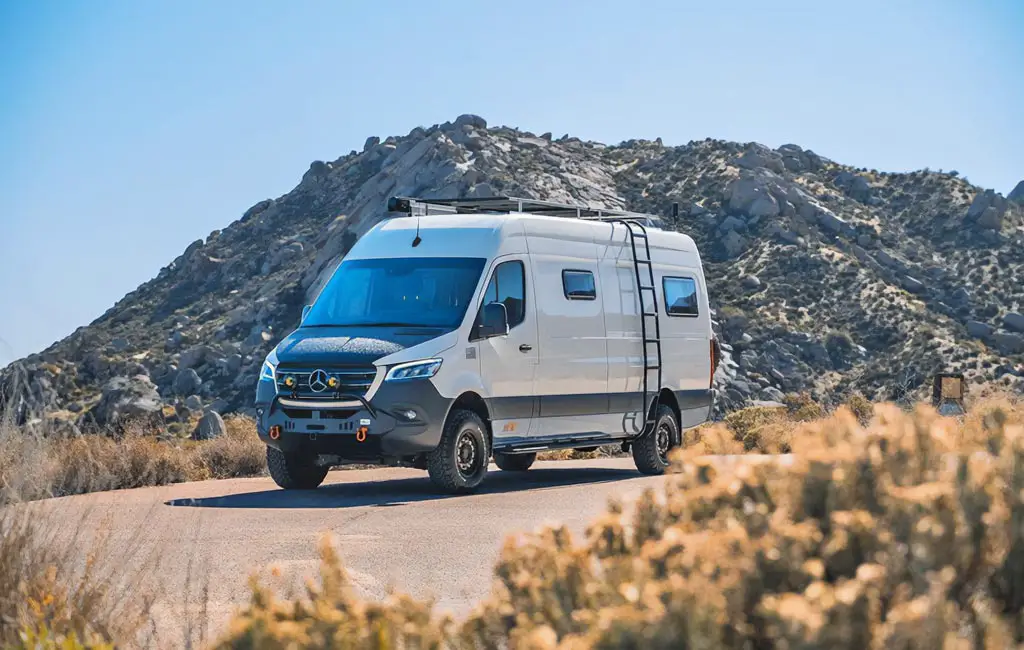 parked sprinter campervan on the road in the mountains