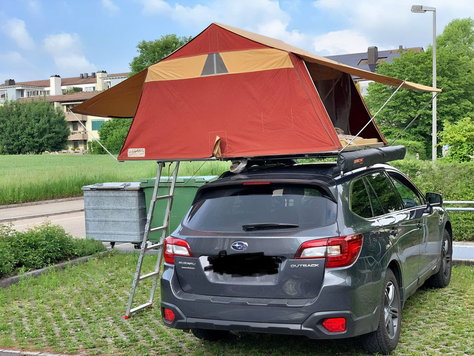 red roof tent on a subaru outback